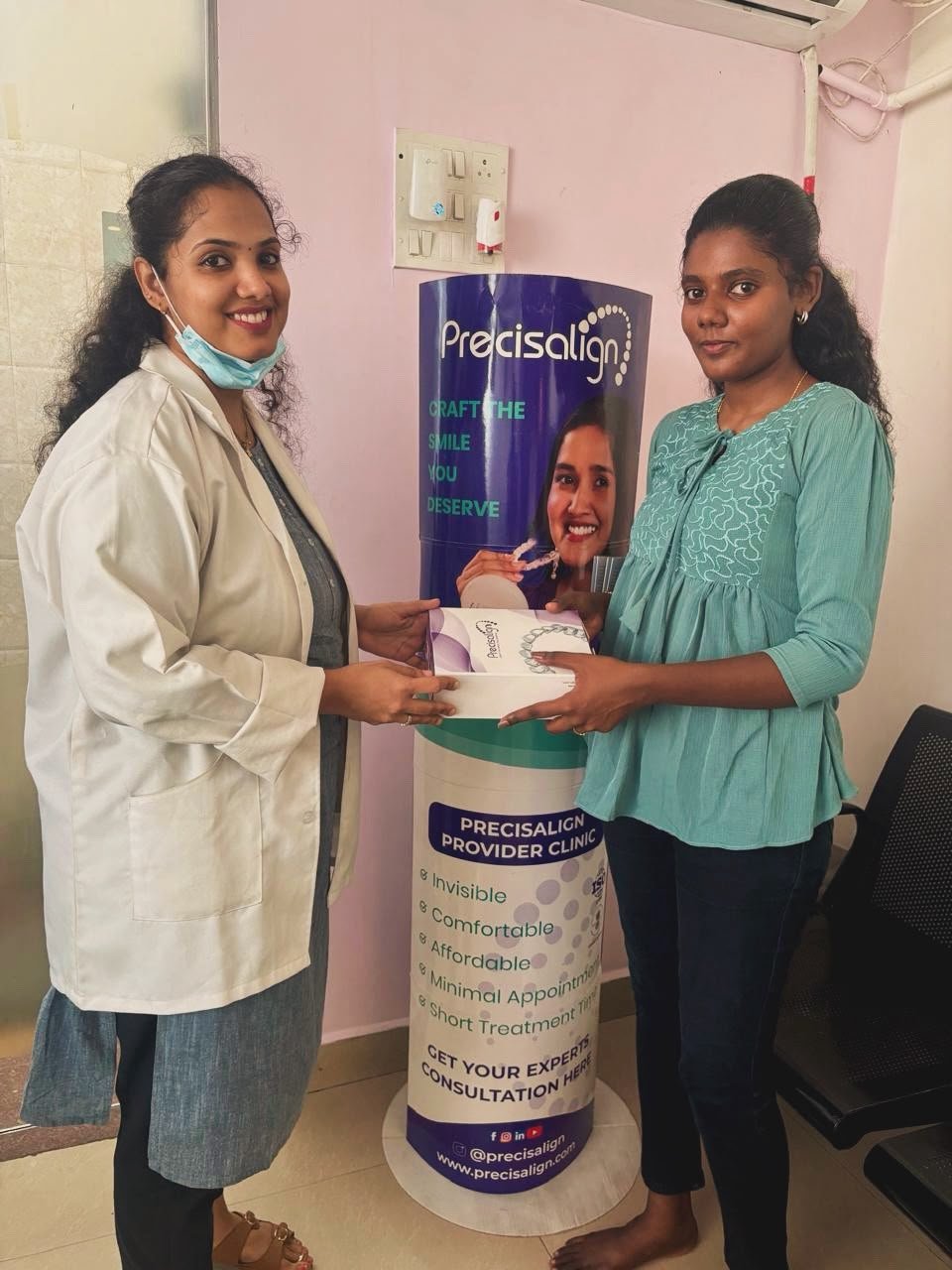 Doctor handing over Precisalign aligner kit to patient at Glodent Chennai